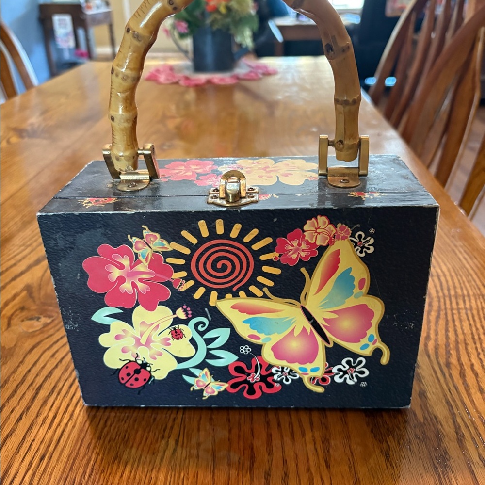 Butterfly and flower purse box with bamboo handle.